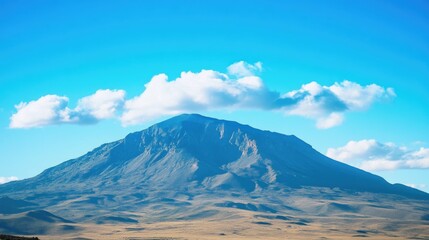 Fototapeta premium A large mountain with a few clouds in the sky