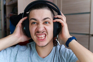 Enjoying an intense moment of music while gaming in a cozy room during the late evening hours