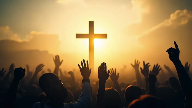 Christian worshipers raising hands up in the air in front of the cross