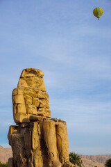 Majestic Colossi of Memnon in Luxor Egypt With Hot Air Balloons in the Sky Over the Historic...