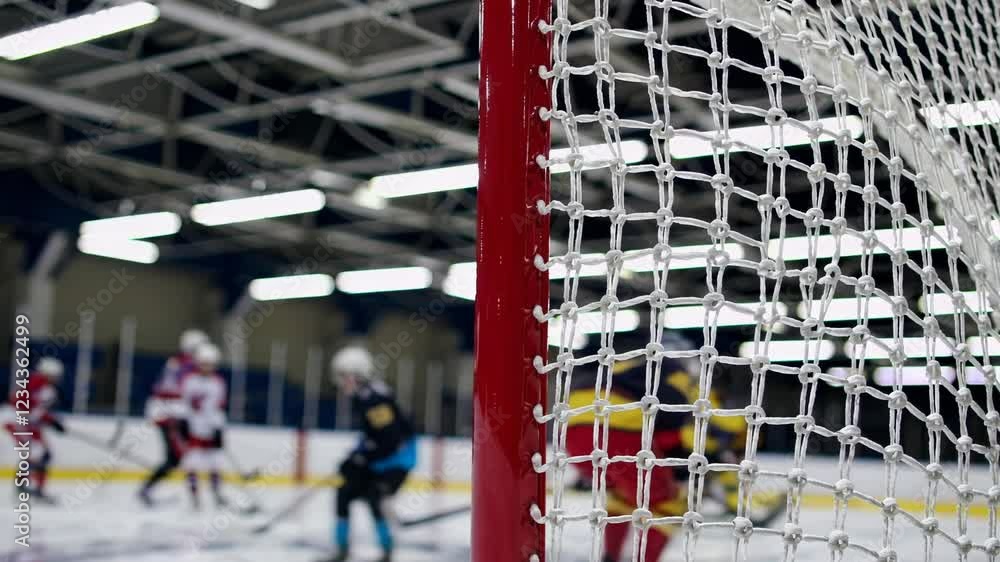 Aufkleber a low-angle perspective of the hockey net’s red frame against the polished ice, with a dynamic blur 