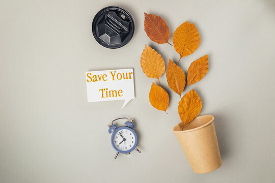 Clock and a cup with leaves on it
