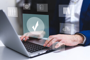 Businessman using laptop with icons of Quality Assurance and Certification Concept. Technology and...