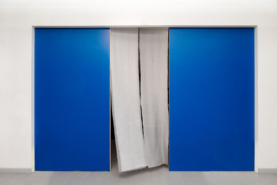 Minimalist Interior Design with Blue Door Panels and Soft Curtain