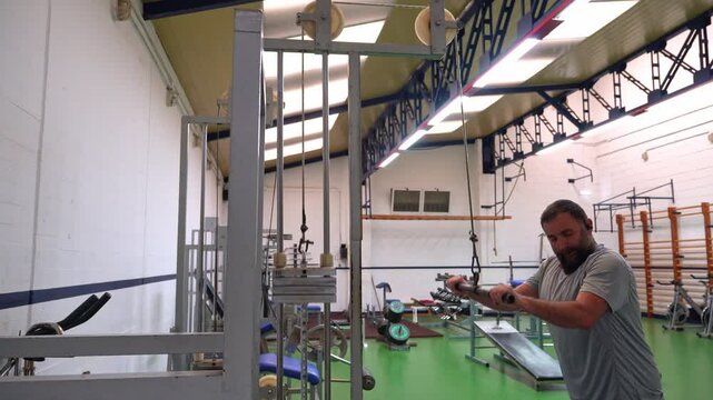A young man working out in the gym, lifting weights and using machines for strength training. Perfect for fitness and motivation content.
