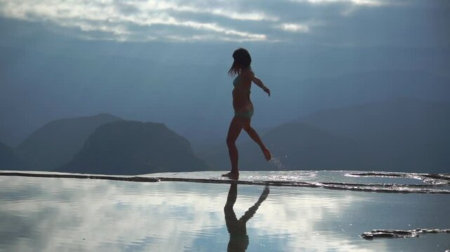 Asian Girl in Bikini is Dancing on the Edge of Natural Petrified Waterfall Hierve el Agua in Mexico, Oaxaca. Travelling.