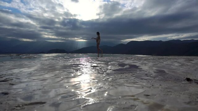 Asian Girl in Bikini is Dancing on the Edge of Natural Petrified Waterfall Hierve el Agua in Mexico, Oaxaca. Travelling.