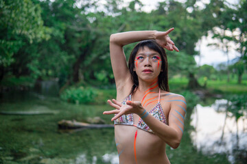 Asian Girl in Bikini is Dancing on the Edge of Clif in Jungle in Mexico, Oaxaca State. Traveller Indonesian Girl.