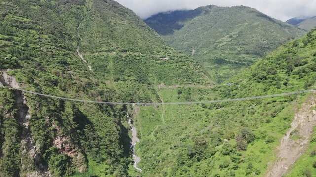 wire bridge in Nepal with beautiful mountain