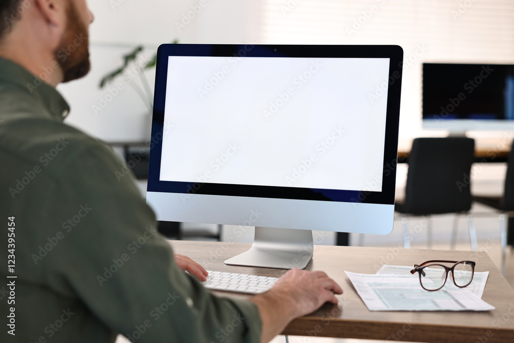 Poster man working on computer at table in office, closeup