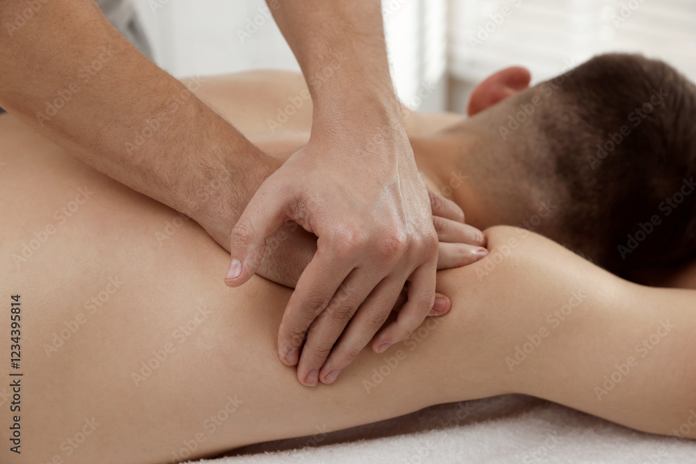 Wall mural Massage therapist working with patient in clinic, closeup