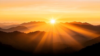 Obraz premium Golden Sunrise Over Silhouetted Mountains