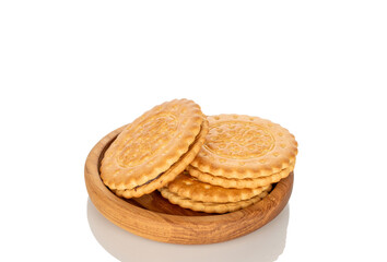 Three cookies on a wooden saucer, macro, isolated on a white background.