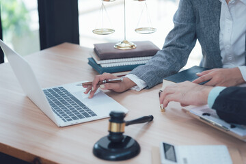 Legal Consultation: A close-up image of a lawyer and client engaged in a confidential legal consultation, emphasizing professionalism and trust.