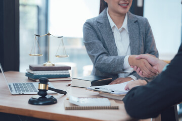 Legal Handshake: A lawyer extends a hand in a firm handshake to a client, signifying trust, legal representation, and the start of a collaborative journey toward justice.