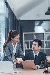 Legal Consultation: A focused discussion between a male and female legal professional in a modern office setting.  The image depicts a serious and professional atmosphere.