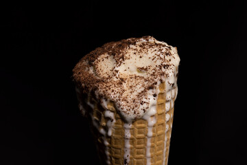 sweet melting white ice cream with chocolate chips in a waffle cone