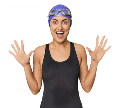 Young Caucasian female professional swimmer receiving a pleasant surprise, excited and raising hands.