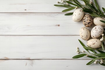 Obraz premium Easter eggs and greenery arranged on white wooden surface