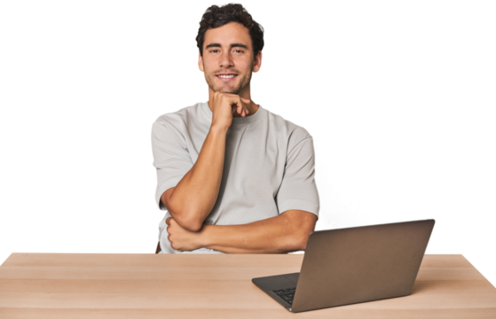 Hispanic young man working on laptop smiling happy and confident, touching chin with hand.