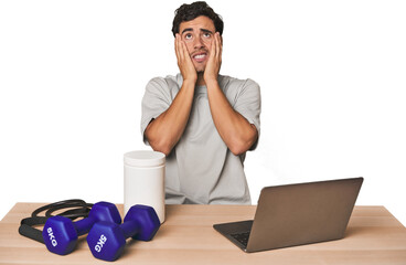 Hispanic trainer planning workout whining and crying disconsolately.