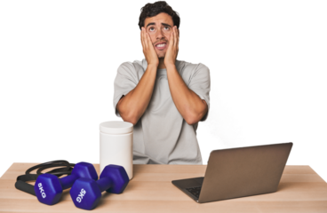 Hispanic trainer planning workout whining and crying disconsolately.