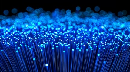 A stunning close-up of glowing blue fiber optic strands, resembling a sea of light, highlighting technology and innovation in communication.