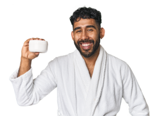 Hispanic male with moisturizer in studio laughing and having fun.