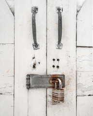 Closeup view of a padlock securing wooden shed doors