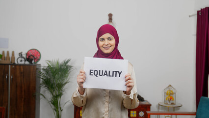 Muslim Woman in Hijab Scarf standing with Equality Poster