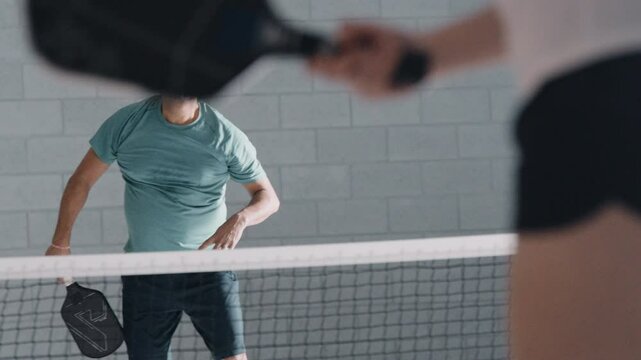Indian man pickleball smash close up