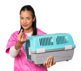 Young Filipina vet holding pet carrier pointing with finger at you as if inviting come closer.