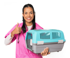 Young Filipina vet holding pet carrier smiling and raising thumb up