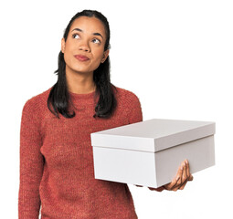 Young Filipina holding a box dreaming of achieving goals and purposes