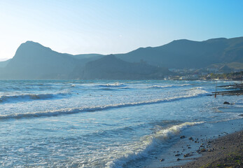 Background landscape view of Sudak Bay, the city of Sudak and its embankment in Crimea