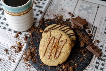 Cup of Coffee and Chocolate on Newspaper Games Page