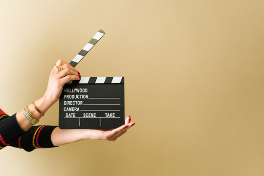 Film director using clapperboard on set for movie production