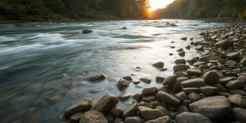 Obraz premium Forest river flowing gently at sunset, with smooth stones on the shores creating a serene and peaceful setting, sunset, tranquil, outdoors