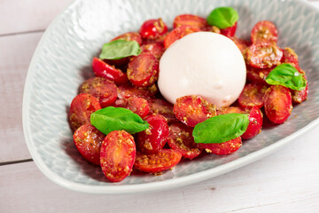 Farmer Italian soft cheese mozzarella served with fresh basil and red cherry tomatoes