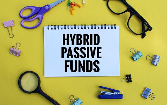 HYBRID MUTUAL FUNDS text written on notebook on chart with calculator and magnifier