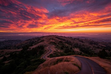 Fototapeta premium Fiery Sunset Over Rolling Hills Wind Turbines Visible