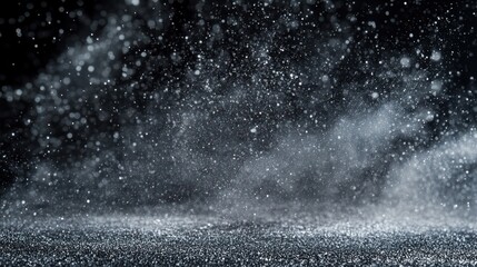 Glittering snow falling on dark studio floor; winter backdrop