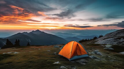 Cozy tent perched atop a mountain under a breathtaking sunset, embracing solitude and nature's grandeur.
