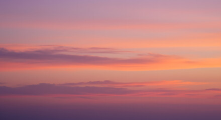Muted sunset gradient with warm orange, pink, and deep purple tones