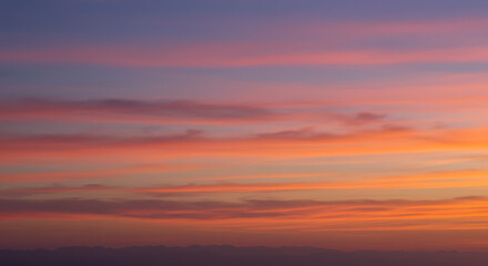 Muted sunset gradient with warm orange, pink, and deep purple tones