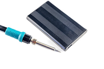 Damaged external drive SSD HDD , transformer soldering iron on white background, electronic...