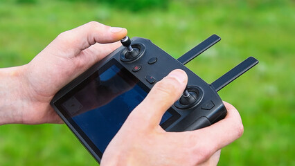 Close-up of a drone operator with a remote control in his hands