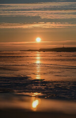 Fototapeta premium sunset over the lake with ice cover