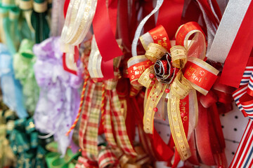 A bunch of red and gold ribbons are hanging on a wall