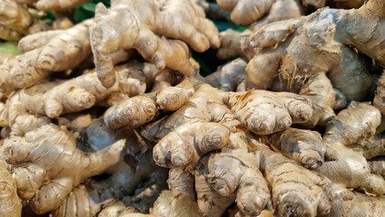 Ginger close-up in the store. Ginger root in the grocery section. Ginger in a plastic box at the food market. Tasty and healthy food. A product for maintaining immunity